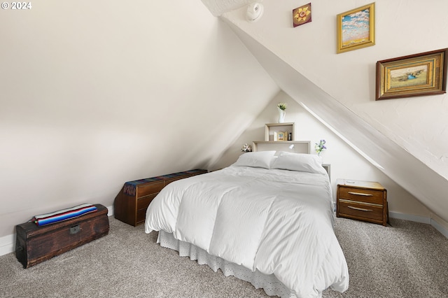 bedroom with vaulted ceiling and carpet floors