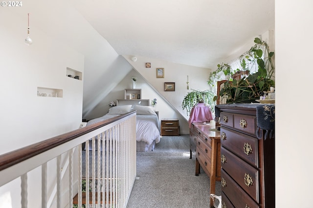 interior space featuring lofted ceiling and dark colored carpet