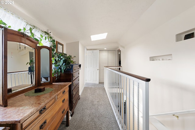 hall featuring a skylight and carpet