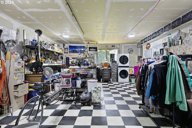 interior space with stacked washer and dryer and a workshop area