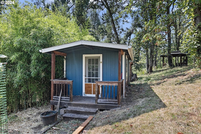 view of outdoor structure featuring a lawn