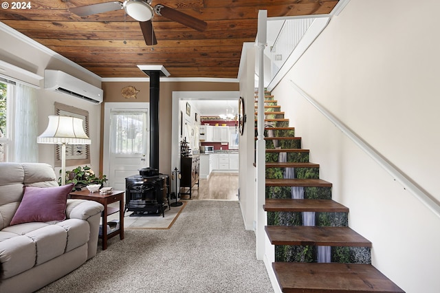 interior space with crown molding, ceiling fan, wooden ceiling, an AC wall unit, and a wood stove