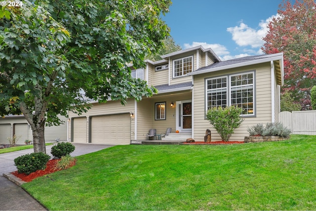 view of front of property featuring a garage and a front lawn