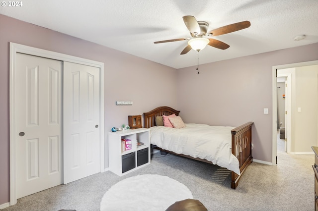 carpeted bedroom featuring a closet and ceiling fan