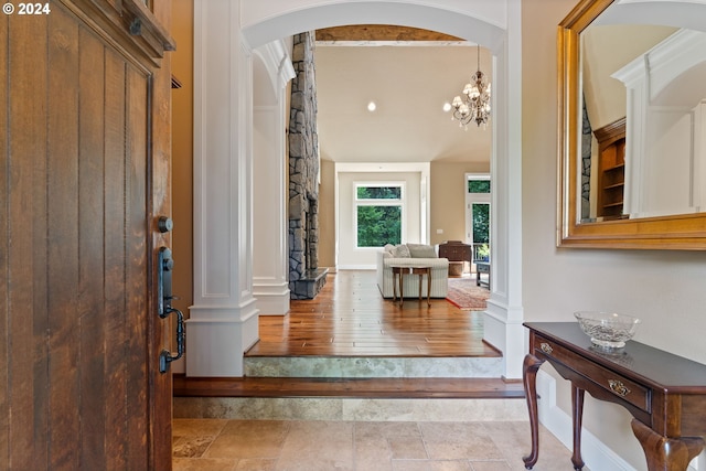 12320 NW Sargent Ln, Portland, OR 97231 - entrance foyer with decorative columns, arched walkways, wood finished floors, and baseboards