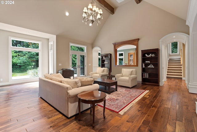 living room featuring beam ceiling, high vaulted ceiling, dark wood-type flooring, and an inviting chandelier