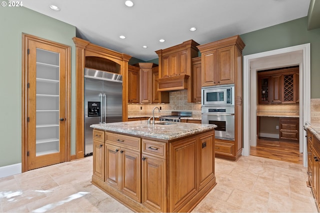12320 NW Sargent Ln, Portland, OR 97231 - kitchen featuring built in appliances, a sink, backsplash, light stone countertops, and recessed lighting