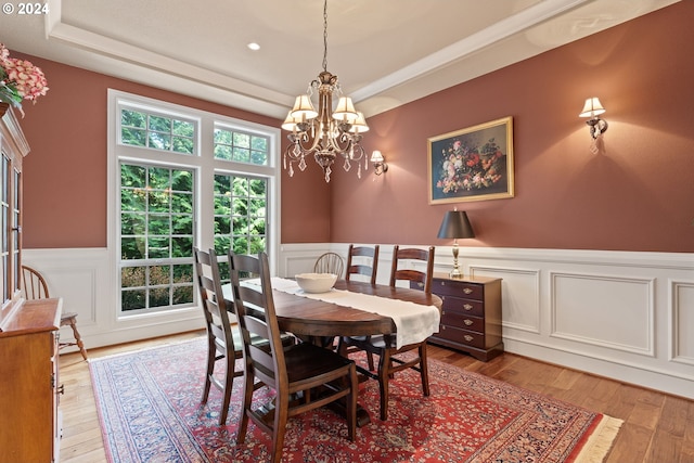 dining room featuring wood-type flooring and a chandelier