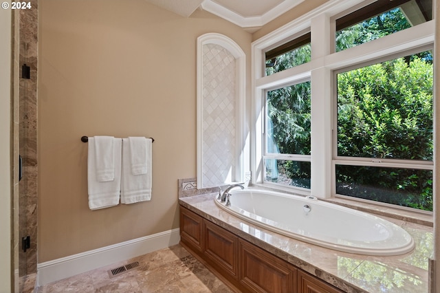 bathroom with plenty of natural light and a tub