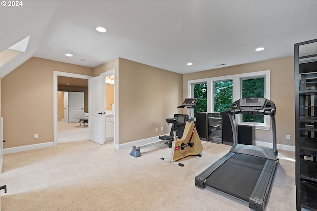 workout room featuring carpet and lofted ceiling