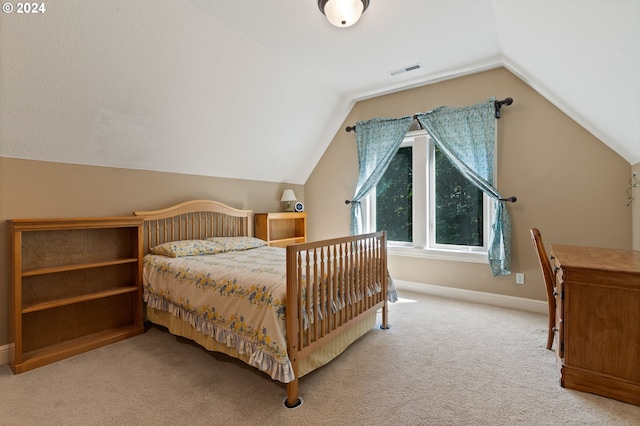 carpeted bedroom featuring vaulted ceiling