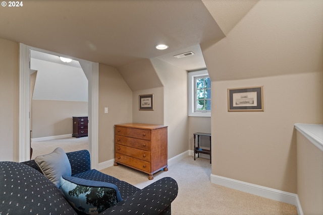 bedroom featuring light carpet and lofted ceiling