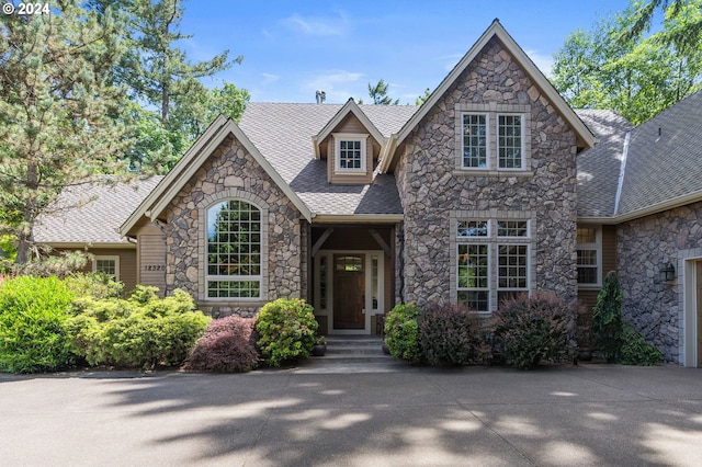 12320 NW Sargent Ln, Portland, OR 97231 - view of front facade with stone siding and a shingled roof