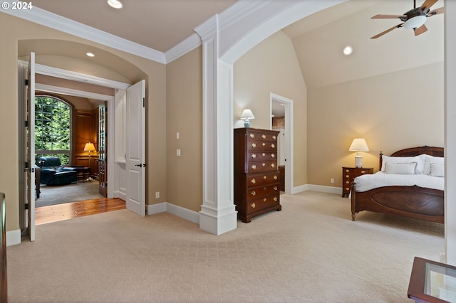 bedroom with ceiling fan, decorative columns, crown molding, light colored carpet, and lofted ceiling