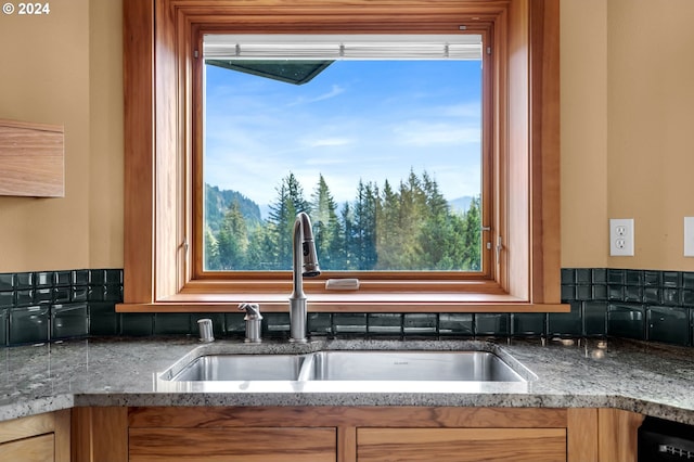 kitchen featuring black dishwasher, plenty of natural light, and sink