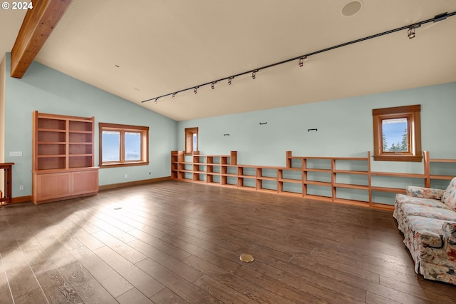 unfurnished living room with vaulted ceiling with beams, rail lighting, and dark hardwood / wood-style floors