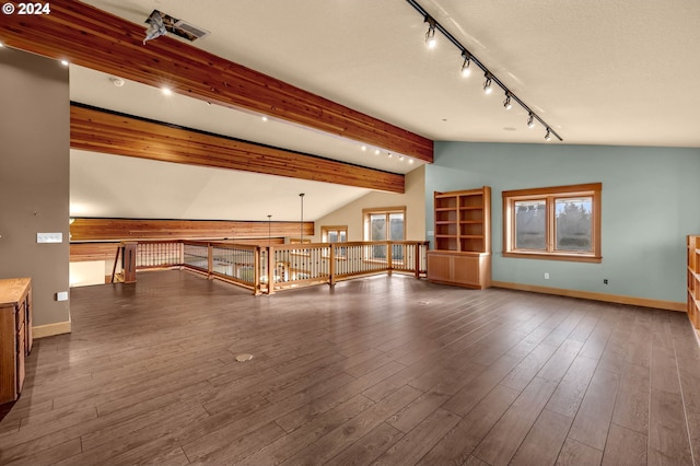 interior space with vaulted ceiling with beams, dark hardwood / wood-style floors, and rail lighting