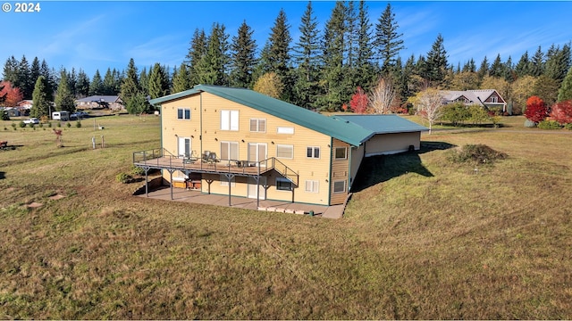 rear view of property with a patio area, a yard, and a wooden deck