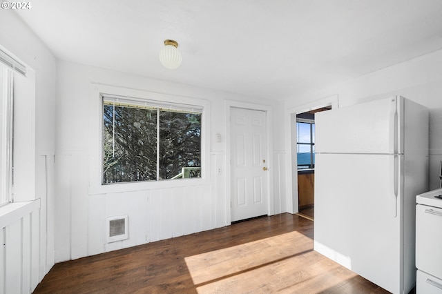 interior space featuring dark hardwood / wood-style flooring and white appliances