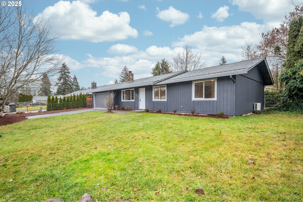 ranch-style home with a front lawn and a garage