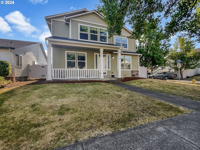 view of front of home featuring covered porch and a front lawn