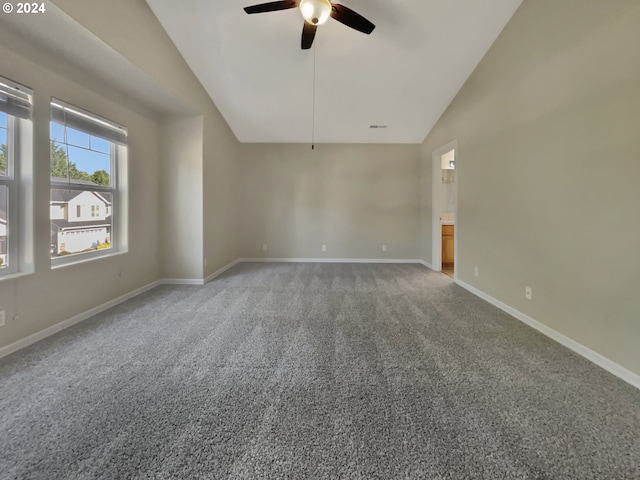 carpeted spare room with ceiling fan and vaulted ceiling