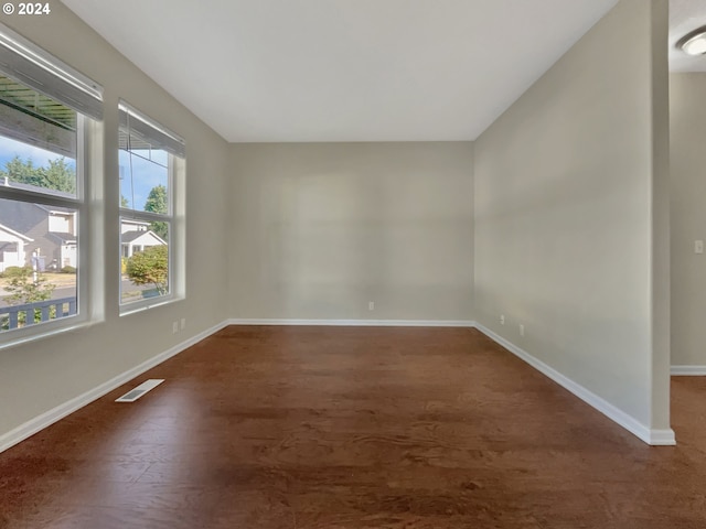 unfurnished room with dark hardwood / wood-style floors