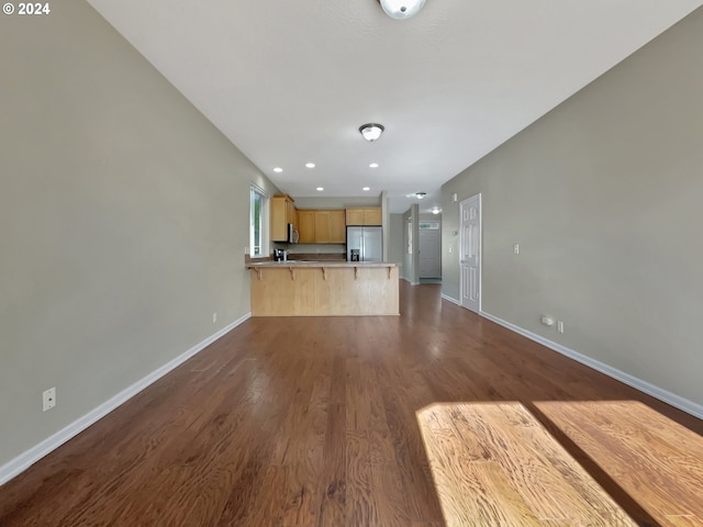 unfurnished living room featuring dark hardwood / wood-style flooring