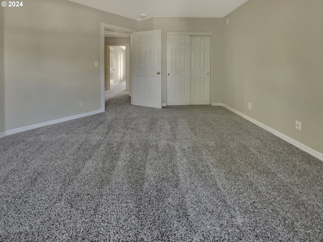 unfurnished bedroom with a closet and carpet flooring