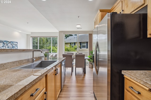 kitchen with sink, light hardwood / wood-style flooring, light brown cabinets, and stainless steel appliances