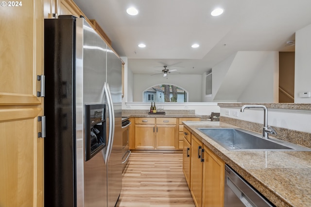 kitchen featuring ceiling fan, stainless steel appliances, light brown cabinets, sink, and light hardwood / wood-style flooring