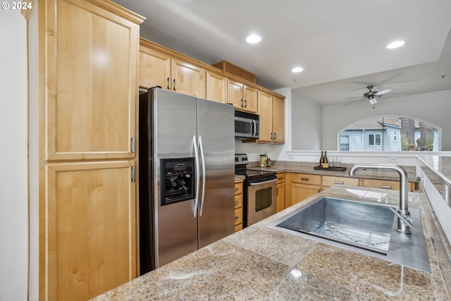 kitchen featuring light brown cabinetry, sink, appliances with stainless steel finishes, and ceiling fan