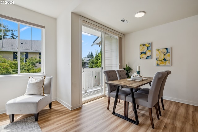 dining area featuring a wealth of natural light and light hardwood / wood-style floors