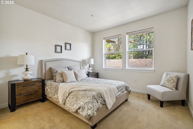 bedroom featuring light colored carpet