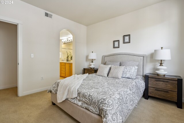 carpeted bedroom with connected bathroom