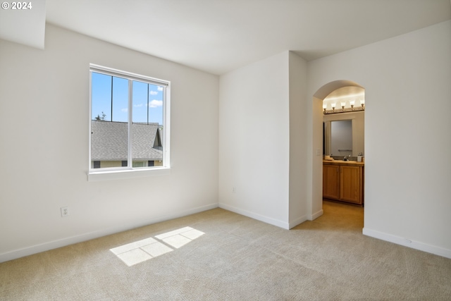 unfurnished room with light carpet