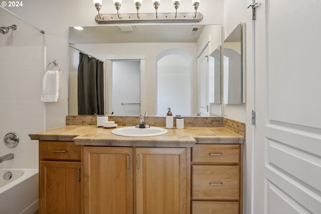 bathroom with vanity and shower / bath combo with shower curtain