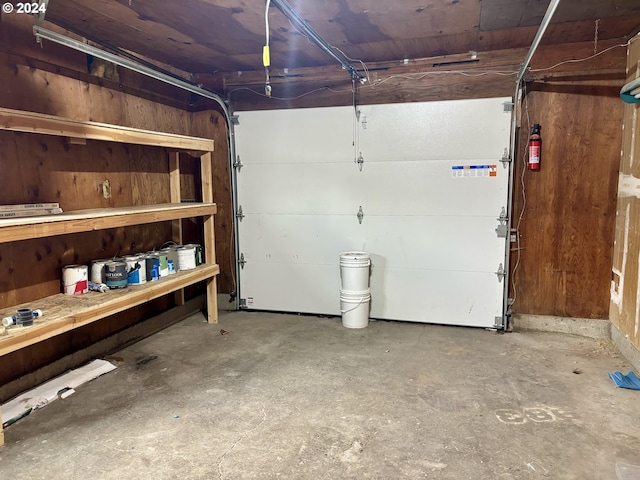 garage featuring wooden walls