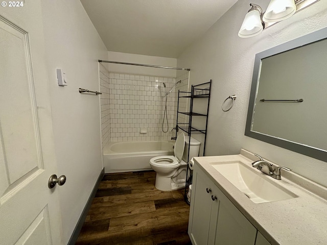 full bathroom with toilet, vanity, tiled shower / bath combo, and hardwood / wood-style flooring