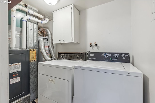 washroom featuring cabinets and independent washer and dryer