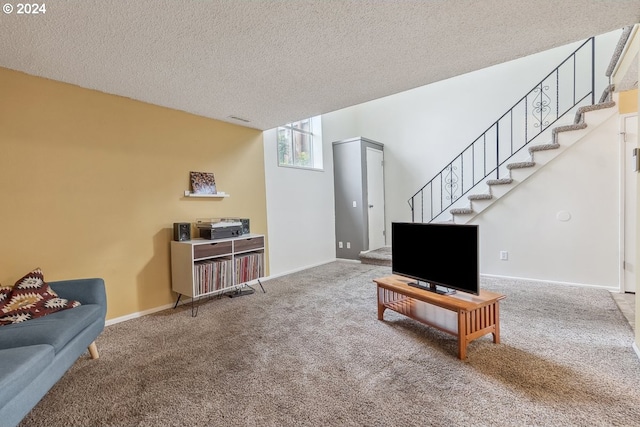 carpeted living room featuring a textured ceiling