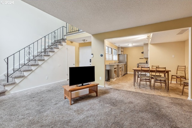 carpeted living room with a textured ceiling