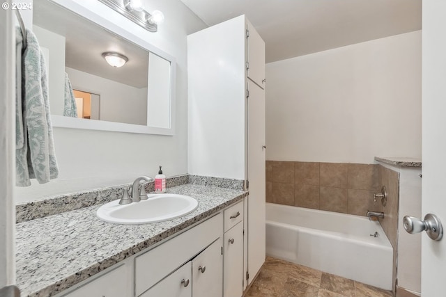 bathroom featuring vanity and a tub to relax in