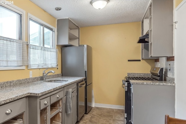 kitchen featuring sink, extractor fan, a textured ceiling, gray cabinets, and appliances with stainless steel finishes