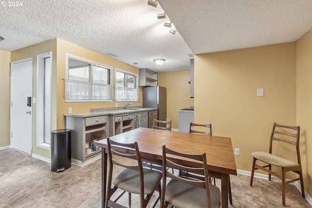 dining room with sink and a textured ceiling