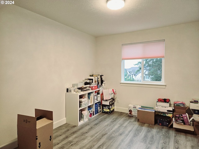 playroom featuring hardwood / wood-style flooring and a textured ceiling