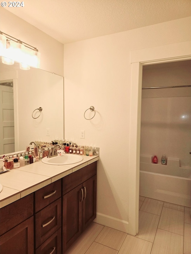 bathroom with a textured ceiling and vanity