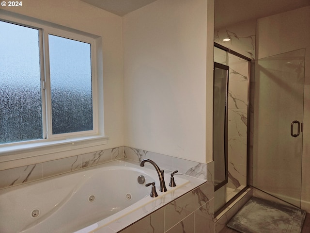 bathroom featuring separate shower and tub