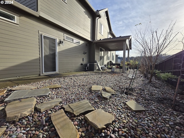 rear view of property with a patio and central AC unit