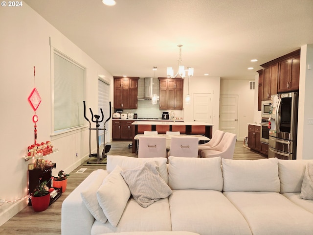 living room featuring wood-type flooring and a notable chandelier